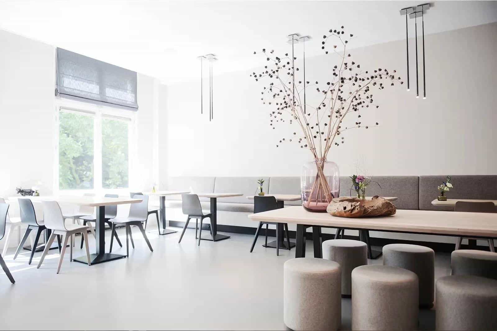 A white room with tables and chairs